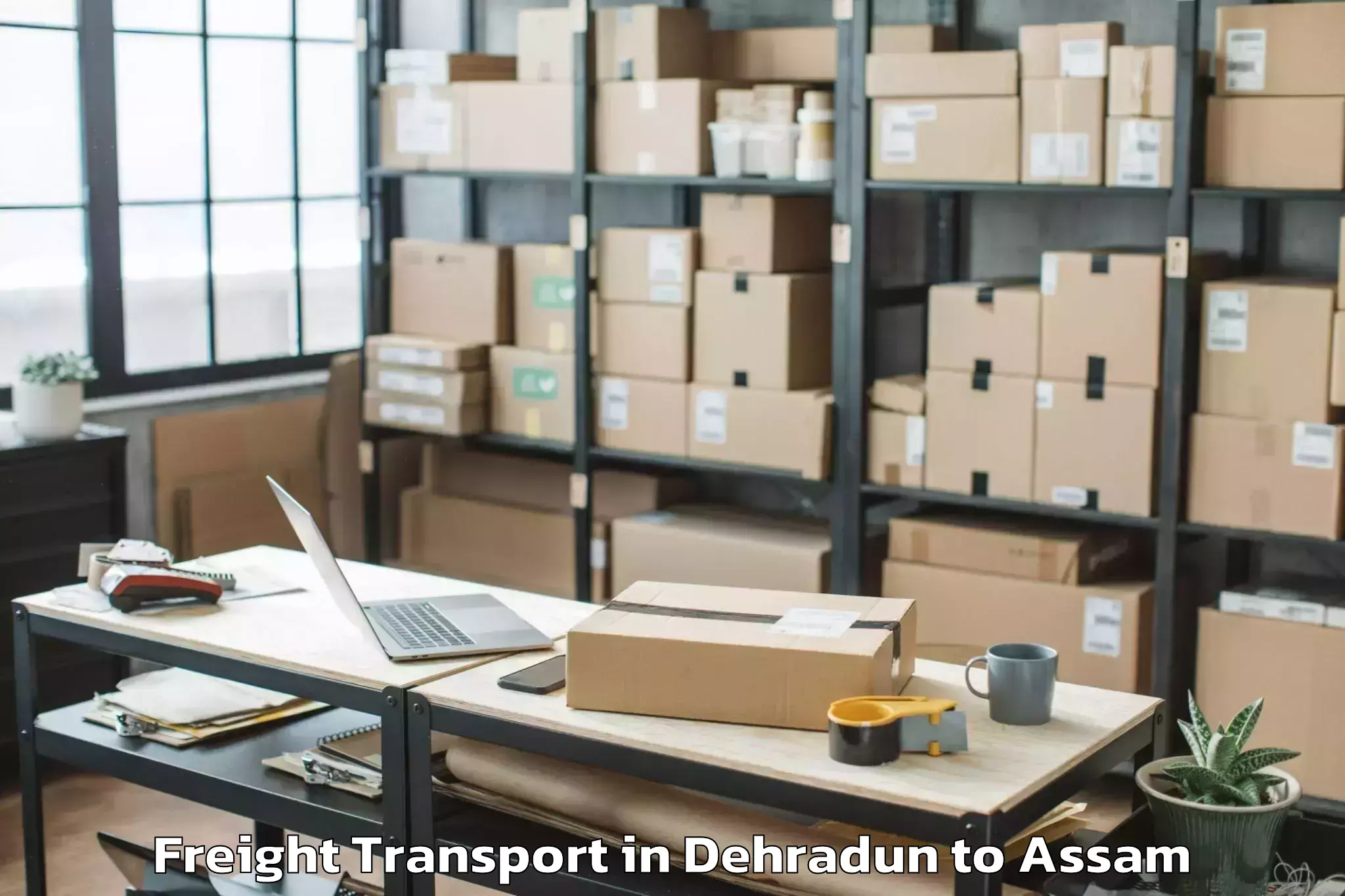 Book Dehradun to Salonibari Airport Tez Freight Transport Online